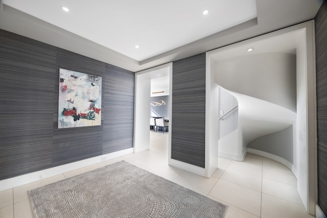 corridor featuring wallpapered walls, recessed lighting, an accent wall, and tile patterned floors