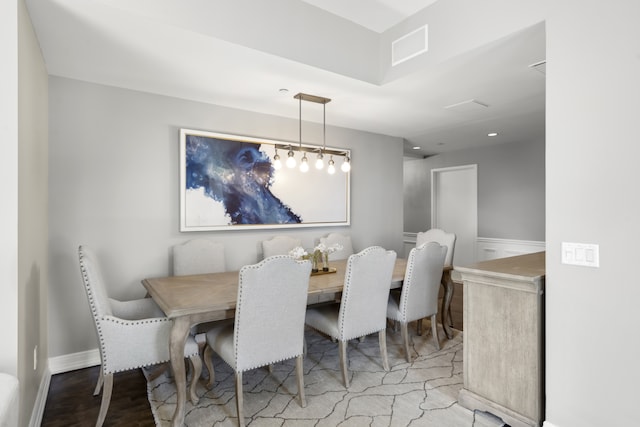 dining space featuring baseboards and wood finished floors