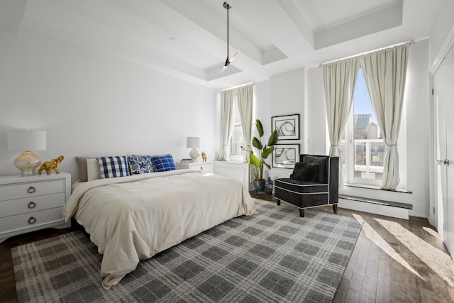 bedroom with a baseboard heating unit, dark wood-type flooring, and beamed ceiling