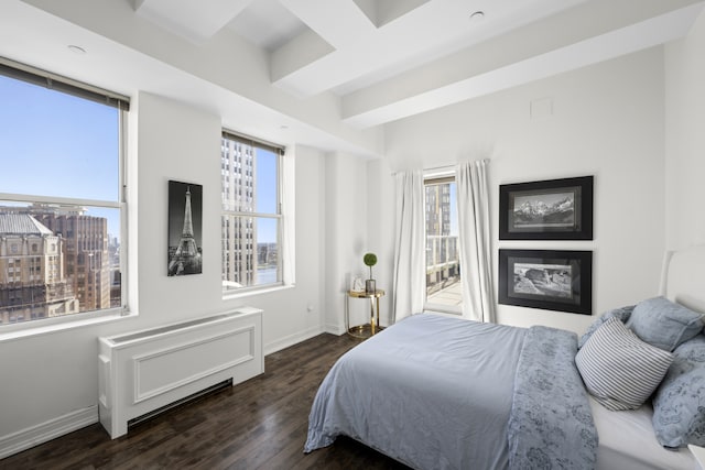 bedroom with baseboards and wood finished floors