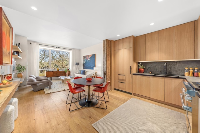 dining area with light wood-style flooring and recessed lighting