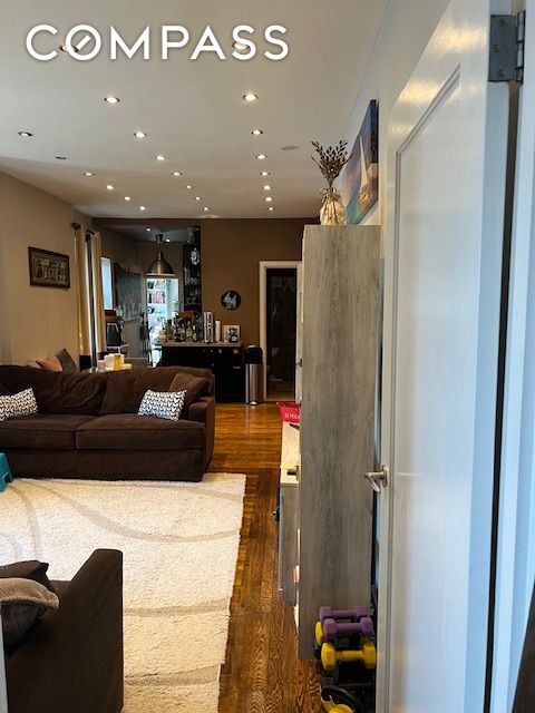 living area featuring dark wood finished floors and recessed lighting