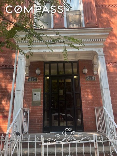 view of exterior entry featuring brick siding