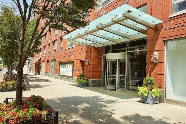 view of exterior entry with brick siding