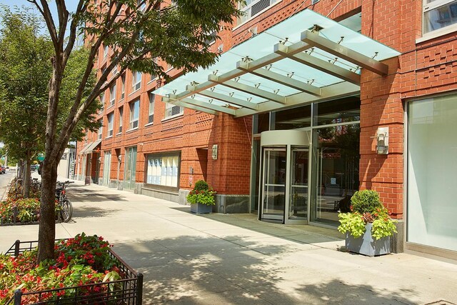 property entrance featuring brick siding