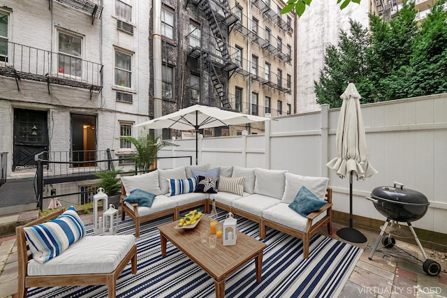 view of patio / terrace with outdoor lounge area, fence, and grilling area