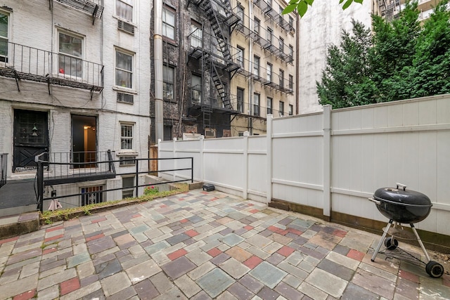 view of patio / terrace with area for grilling and fence