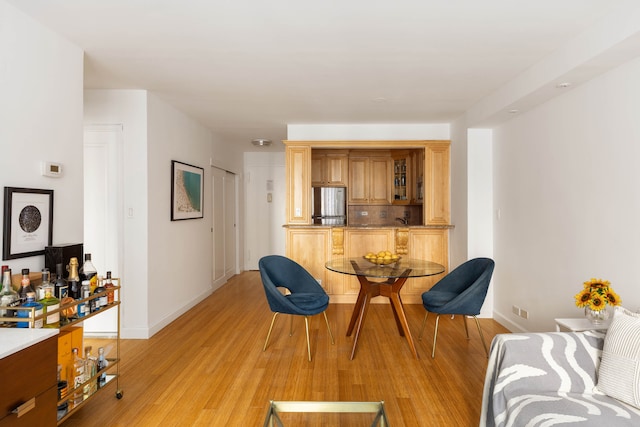 interior space featuring light wood-style flooring and baseboards