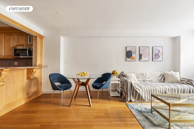 interior space with visible vents, light wood-style flooring, and baseboards