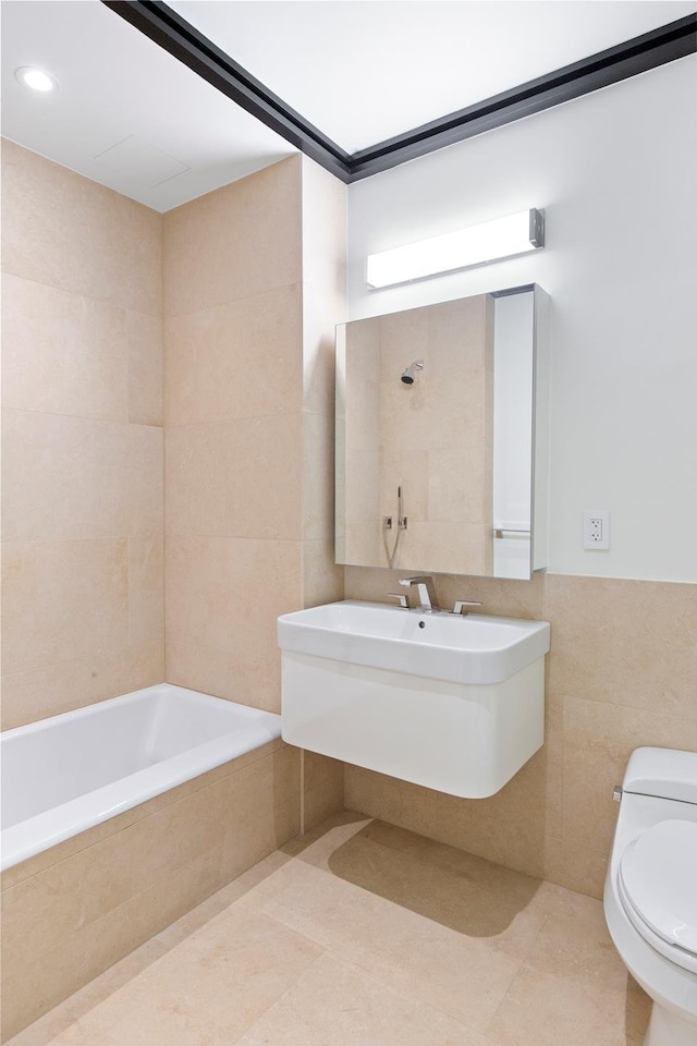 full bathroom featuring a sink, toilet, tile walls, and tile patterned flooring