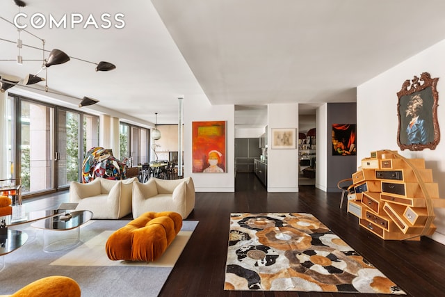 living room featuring wood-type flooring and baseboards