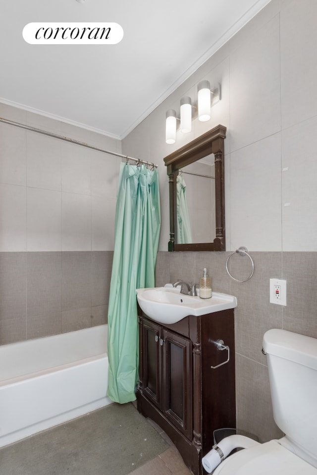 full bathroom featuring toilet, vanity, tile walls, ornamental molding, and shower / tub combo with curtain