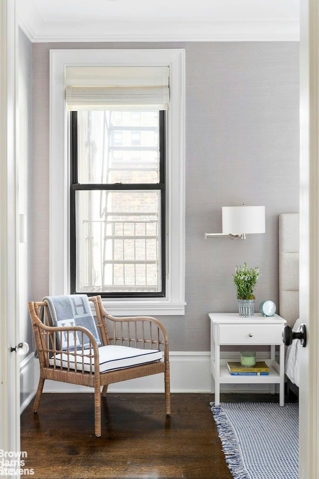 sitting room featuring crown molding, baseboards, and wood finished floors