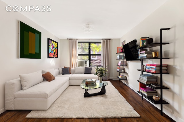 living room with baseboards and dark wood-style flooring