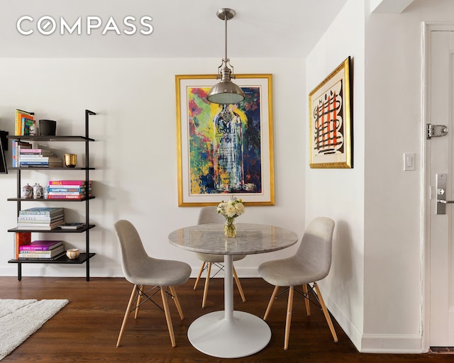 dining room with baseboards and wood finished floors