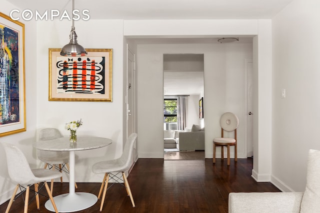 dining area featuring baseboards and wood finished floors