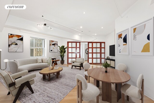 living room featuring light wood-style floors, recessed lighting, and visible vents