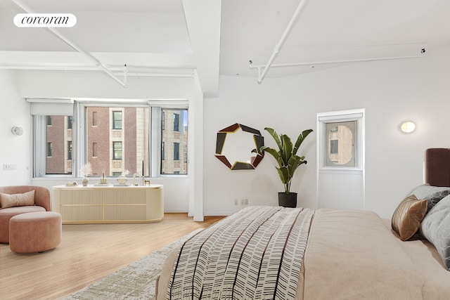 bedroom with light wood-style floors and visible vents