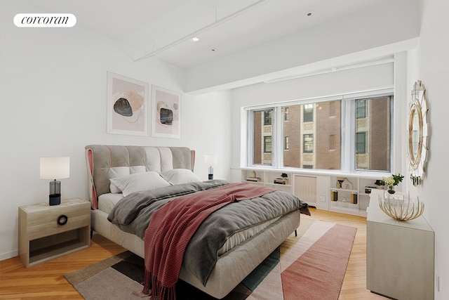 bedroom featuring light wood-type flooring and radiator