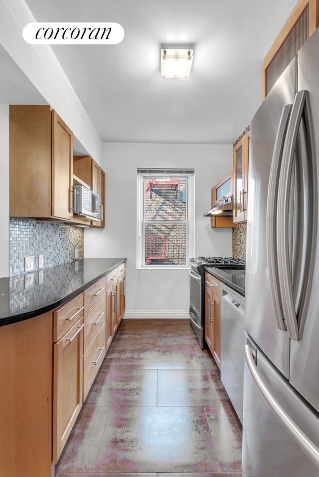 76-15 35th Ave Unit 6O, New York City, NY 11372 - kitchen with dark wood-style flooring, baseboards, appliances with stainless steel finishes, tasteful backsplash, and glass insert cabinets