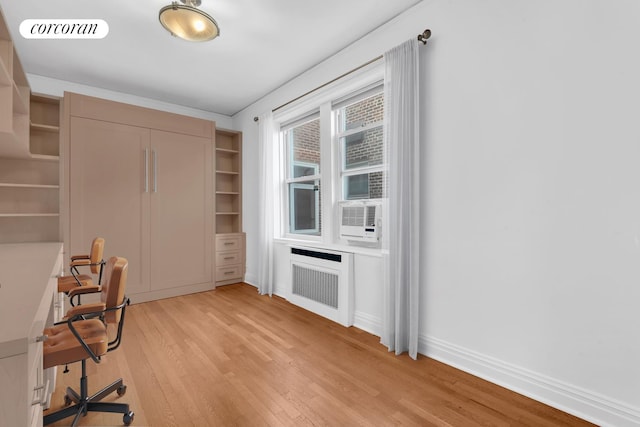 76-15 35th Ave Unit 6O, New York City, NY 11372 - office area with cooling unit, light wood-style flooring, visible vents, baseboards, and radiator