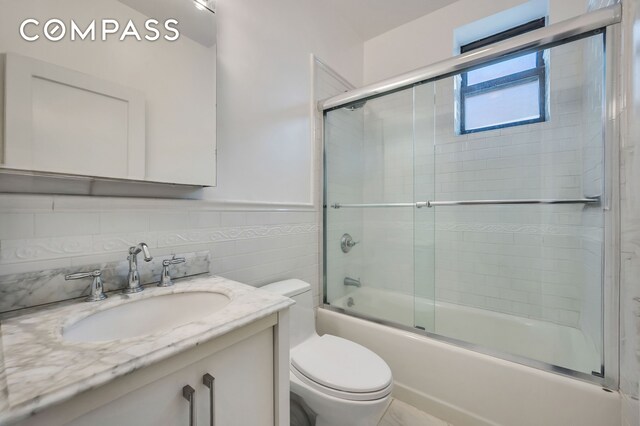 120 2nd Ave Unit 5A, New York City, NY 10003 - full bathroom featuring vanity, enclosed tub / shower combo, and wainscoting