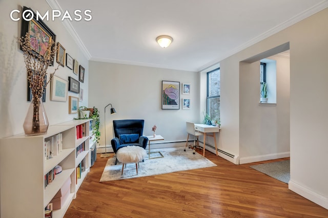 living area with baseboards, wood finished floors, and crown molding