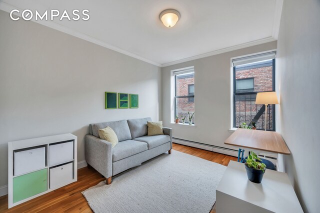 120 2nd Ave Unit 5A, New York City, NY 10003 - living area featuring crown molding, a baseboard heating unit, and wood finished floors