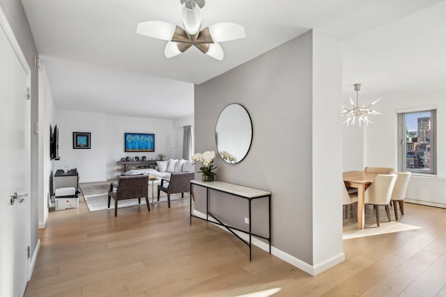 200 E 62nd St Unit 23D, New York City, NY 10065 - hall with light wood-style flooring, a chandelier, and baseboards