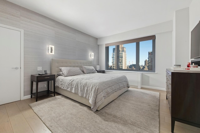 200 E 62nd St Unit 23D, New York City, NY 10065 - bedroom featuring light wood finished floors and baseboards