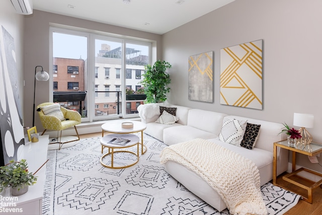 living area with a view of city, wood finished floors, and a wall mounted AC