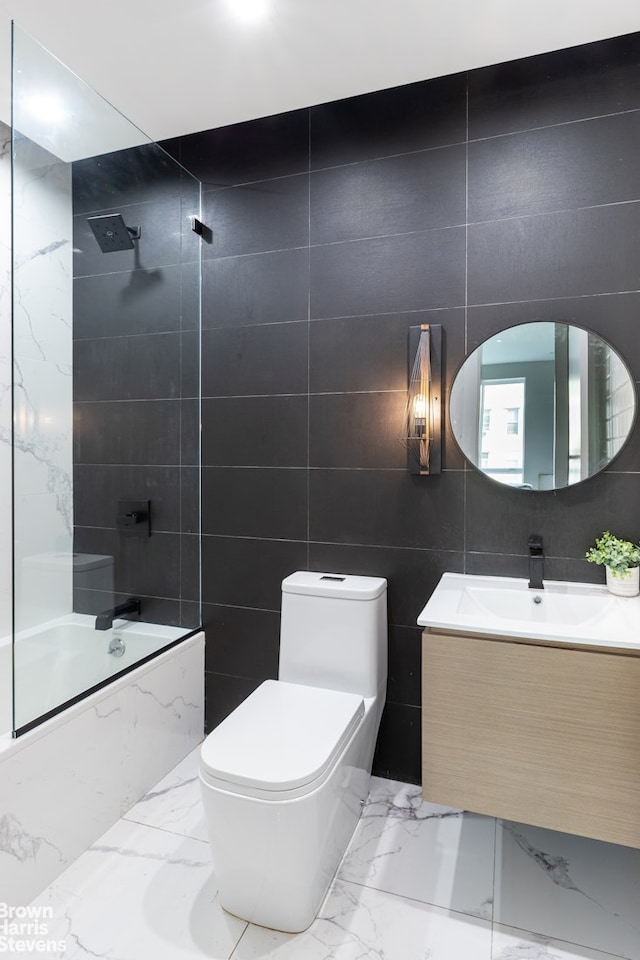 full bathroom with vanity, bathing tub / shower combination, toilet, tile walls, and marble finish floor