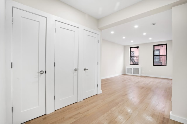 interior space with recessed lighting, visible vents, baseboards, light wood-type flooring, and two closets