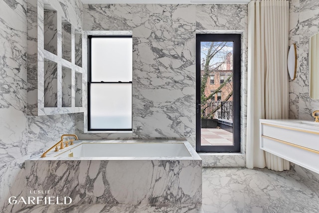 26 W 95th St, New York City, NY 10025 - bathroom with plenty of natural light, vanity, marble finish floor, and a garden tub