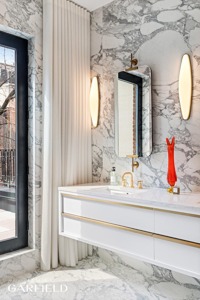 26 W 95th St, New York City, NY 10025 - bathroom featuring marble finish floor, stone wall, and vanity