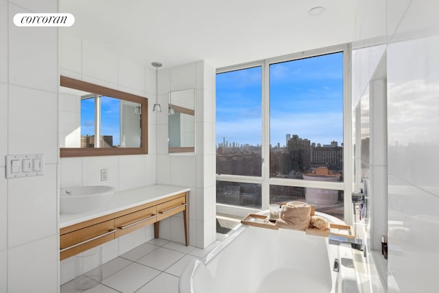 full bath with tile patterned flooring, a view of city, a freestanding bath, and vanity