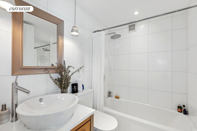 340 E 23rd St Unit Ph1B, New York City, NY 10010 - bathroom with shower / tub combo with curtain, vanity, and toilet