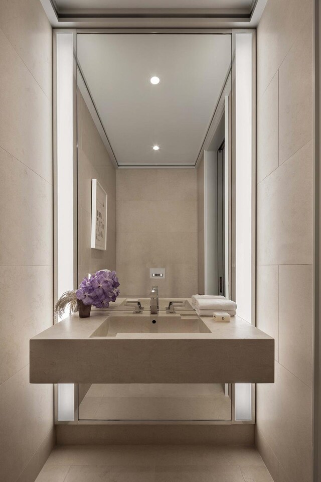 53 W 53rd St Unit 49A, New York City, NY 10019 - bathroom with recessed lighting, vanity, and tile walls