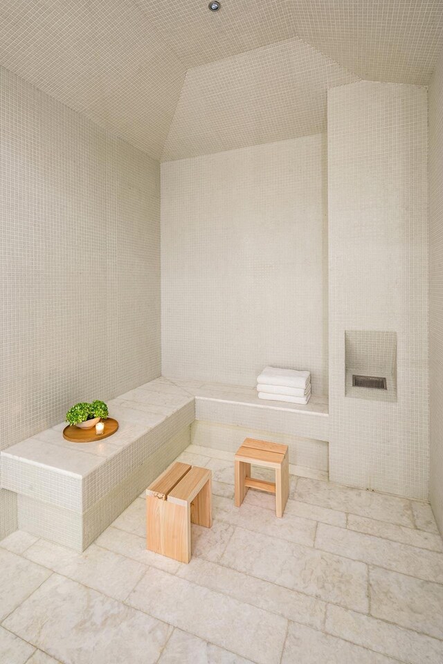 53 W 53rd St Unit 49A, New York City, NY 10019 - bathroom featuring a sauna and lofted ceiling