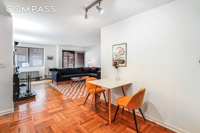 living room with track lighting and baseboards