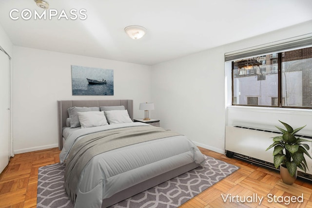 bedroom featuring radiator heating unit and baseboards