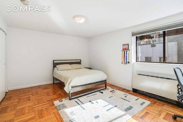 bedroom with radiator and baseboards