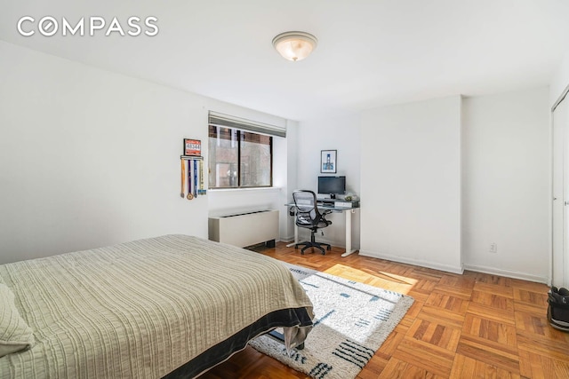 bedroom with radiator and baseboards