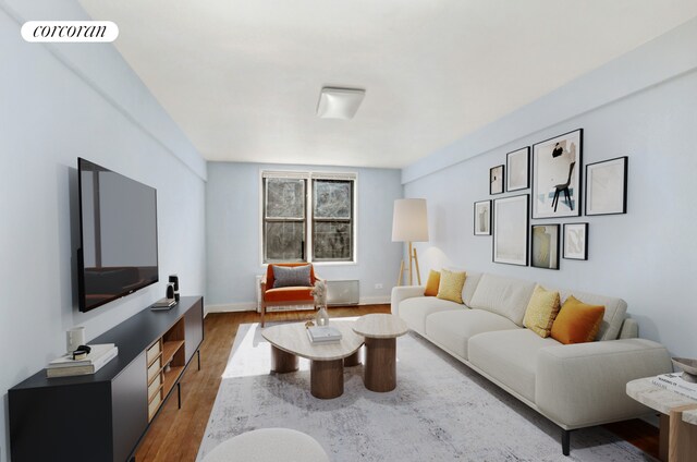 living room featuring wood finished floors, visible vents, and baseboards