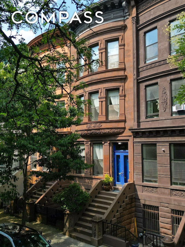 view of front of home with stairway and french doors