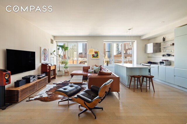 living area featuring visible vents and light wood finished floors