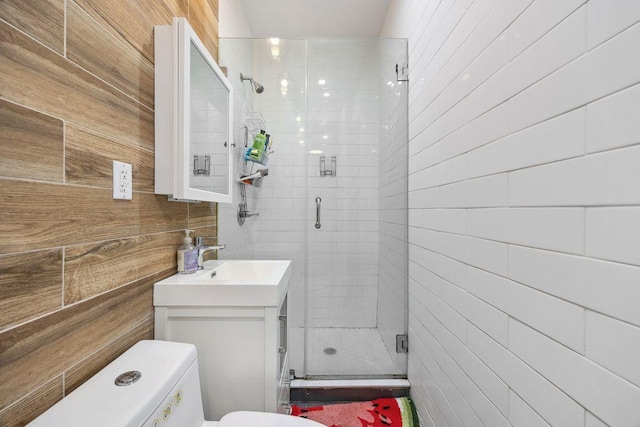 118 Kingsland Ave Unit 1, New York City, NY 11222 - full bathroom featuring a stall shower, toilet, vanity, and tile walls