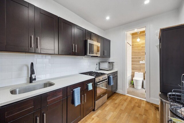 118 Kingsland Ave Unit 1, New York City, NY 11222 - kitchen with appliances with stainless steel finishes, a sink, light countertops, light wood-type flooring, and recessed lighting