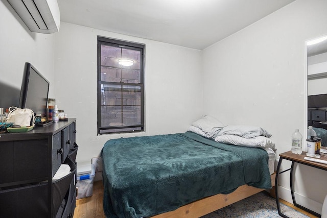 118 Kingsland Ave Unit 1, New York City, NY 11222 - bedroom featuring an AC wall unit and wood finished floors