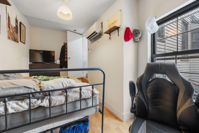 118 Kingsland Ave Unit 1, New York City, NY 11222 - bedroom with wood finished floors, baseboards, and a wall mounted air conditioner